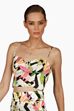 Woman wearing a colorful geometric-patterned two-piece outfit 