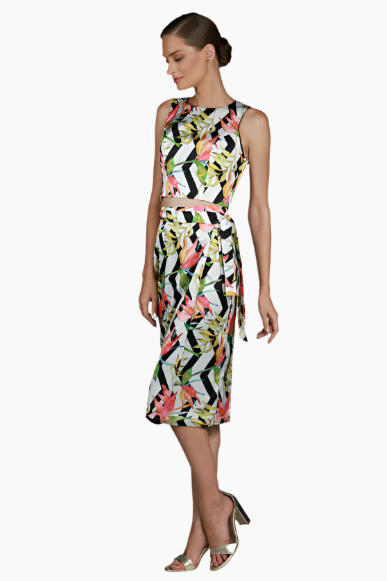 Woman wearing a colorful floral skirt with matching top
