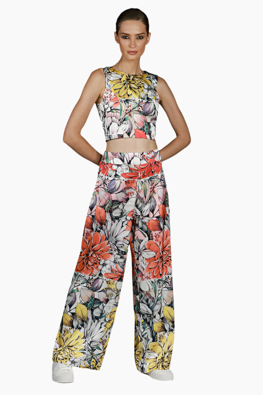 Woman wearing a floral two-piece , d pants with matching top