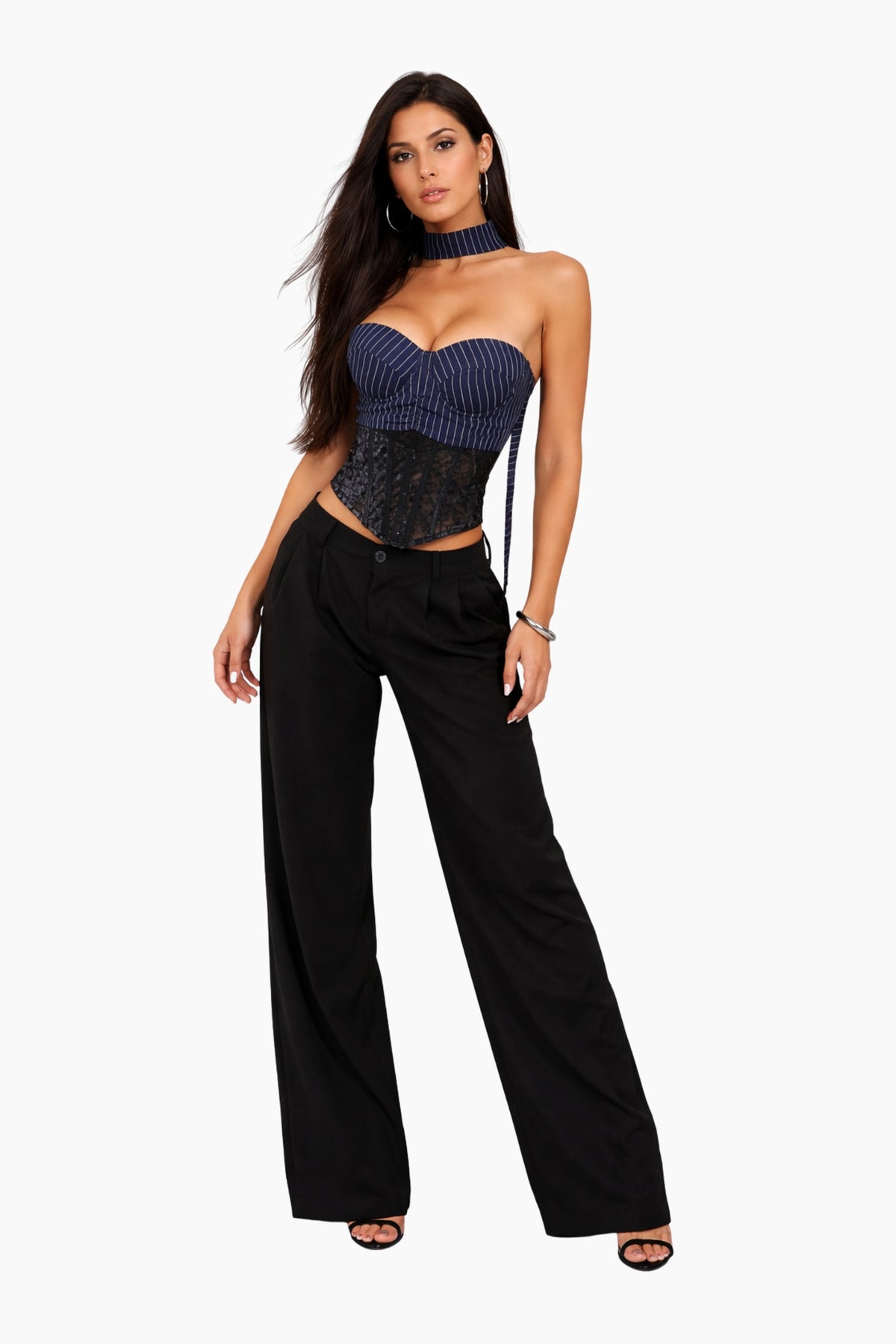 Woman wearing a strapless top and black pants on a white background