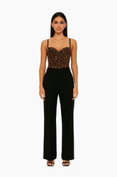 Woman wearing a leopard print top and black pants