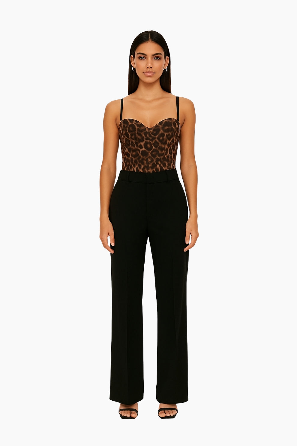 Woman wearing a leopard print top and black pants