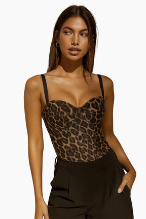 Woman wearing a leopard print top and black pants 