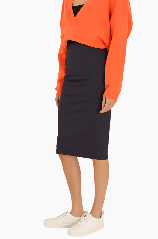 Person wearing an orange sweater and navy skirt 