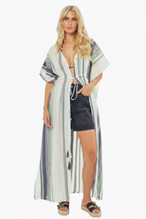 Woman wearing a striped cover-up dress on a white background