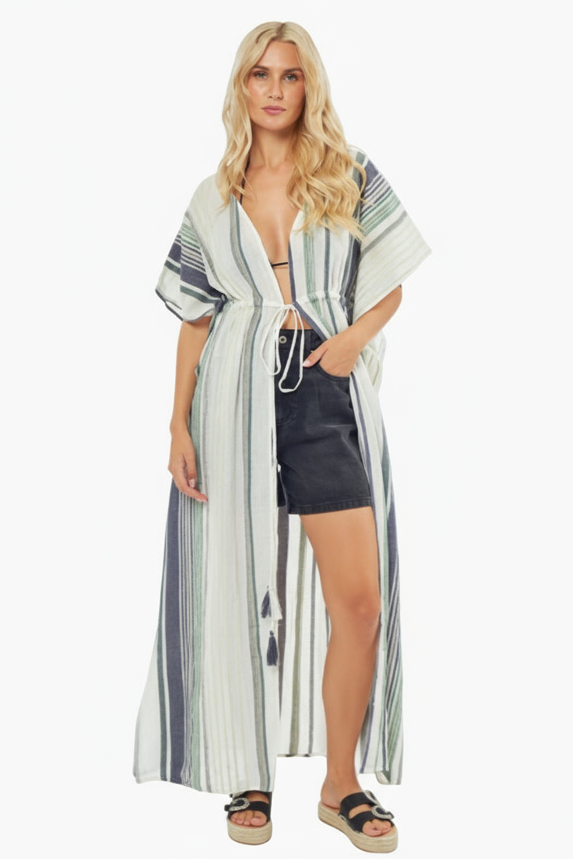 Woman wearing a striped cover-up dress on a white background