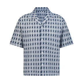A short-sleeved blue and white geometric patterned cotton shirt with a camp collar.