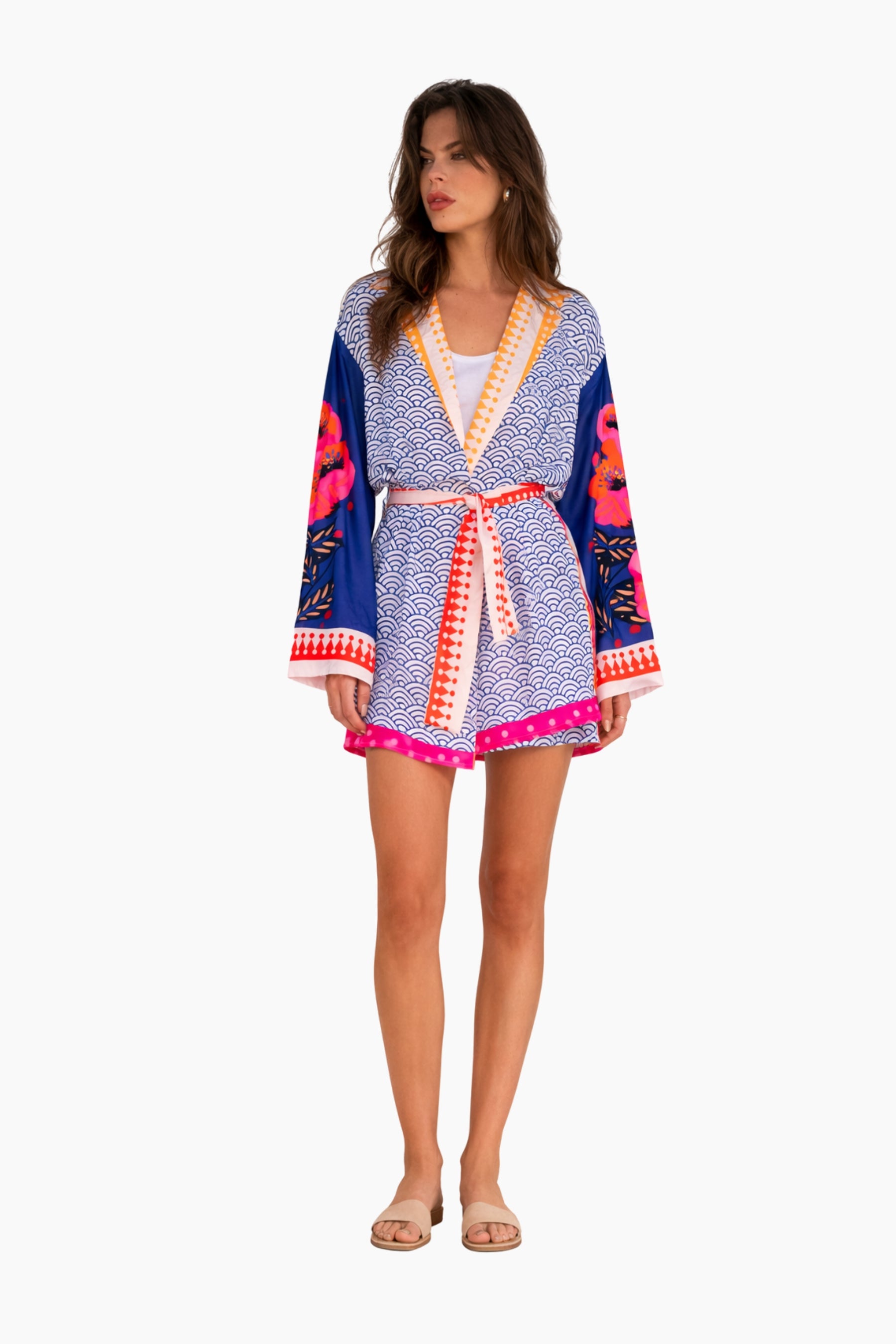 Woman wearing a colorful patterned kimono-style robe on a white background