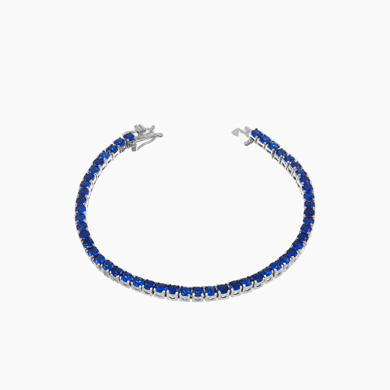 Silver bracelet with blue stones on a white background
