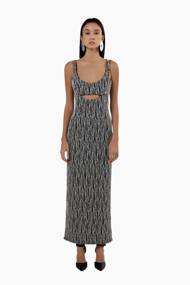 Woman wearing a black and white patterned dress , Straight ankle length dress, straight fit, middle front cut out.