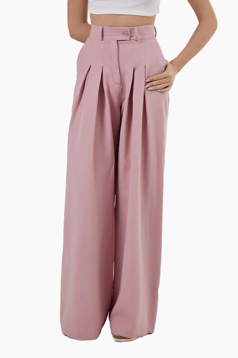 Pink wide-leg pants worn by a person on a white background