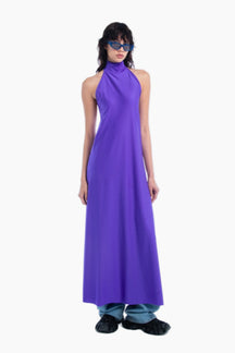 Woman wearing a long purple dress on a white background