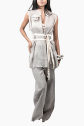 Woman wearing a sleeveless top and wide-leg pants with a belt 