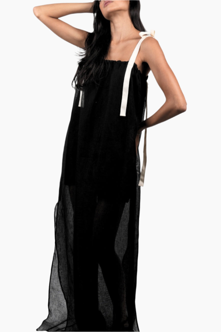 Woman wearing a black dress with white straps 