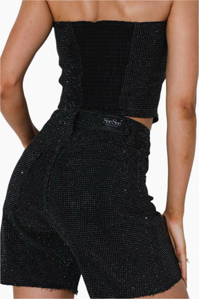 Black sparkly outfit with a brand logo 