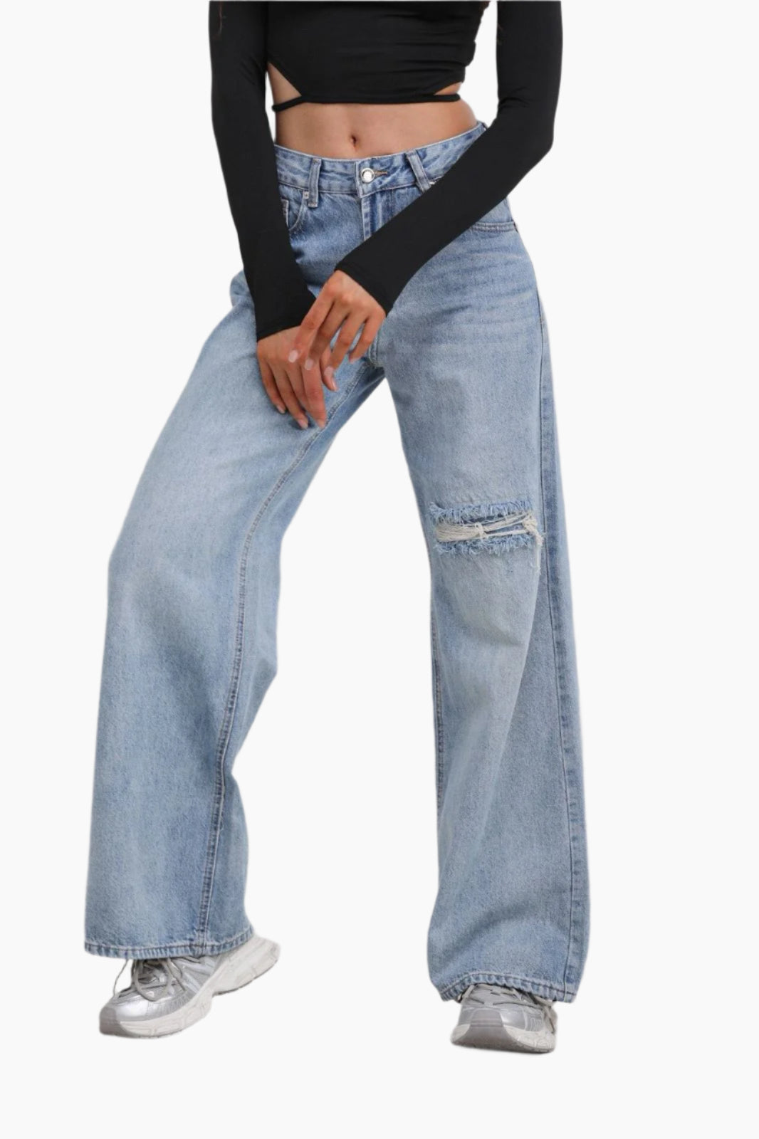 Person wearing light blue jeans with a black top