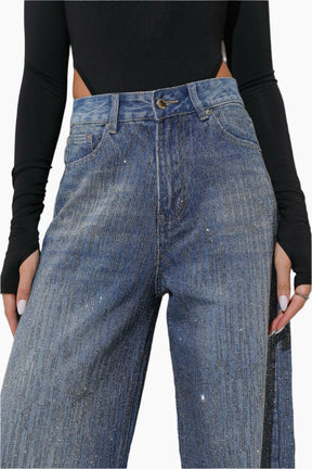 Blue jeans worn by a person with a black long-sleeve top 