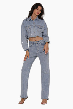 Woman wearing a denim jacket and jeans on a white background