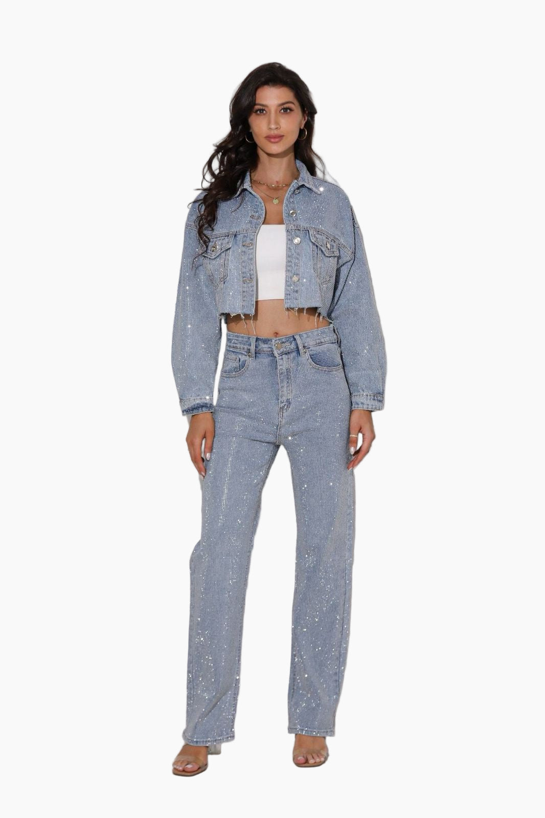 Woman wearing a light blue denim jacket and jeans on a white background