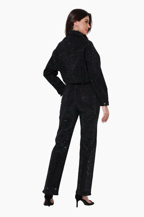Woman wearing a black sequin outfit on a white background