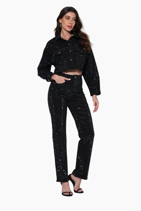 Woman wearing a black sequin outfit on a white background