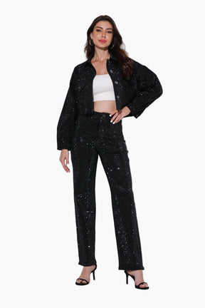 Woman wearing a black sequin outfit on a white background