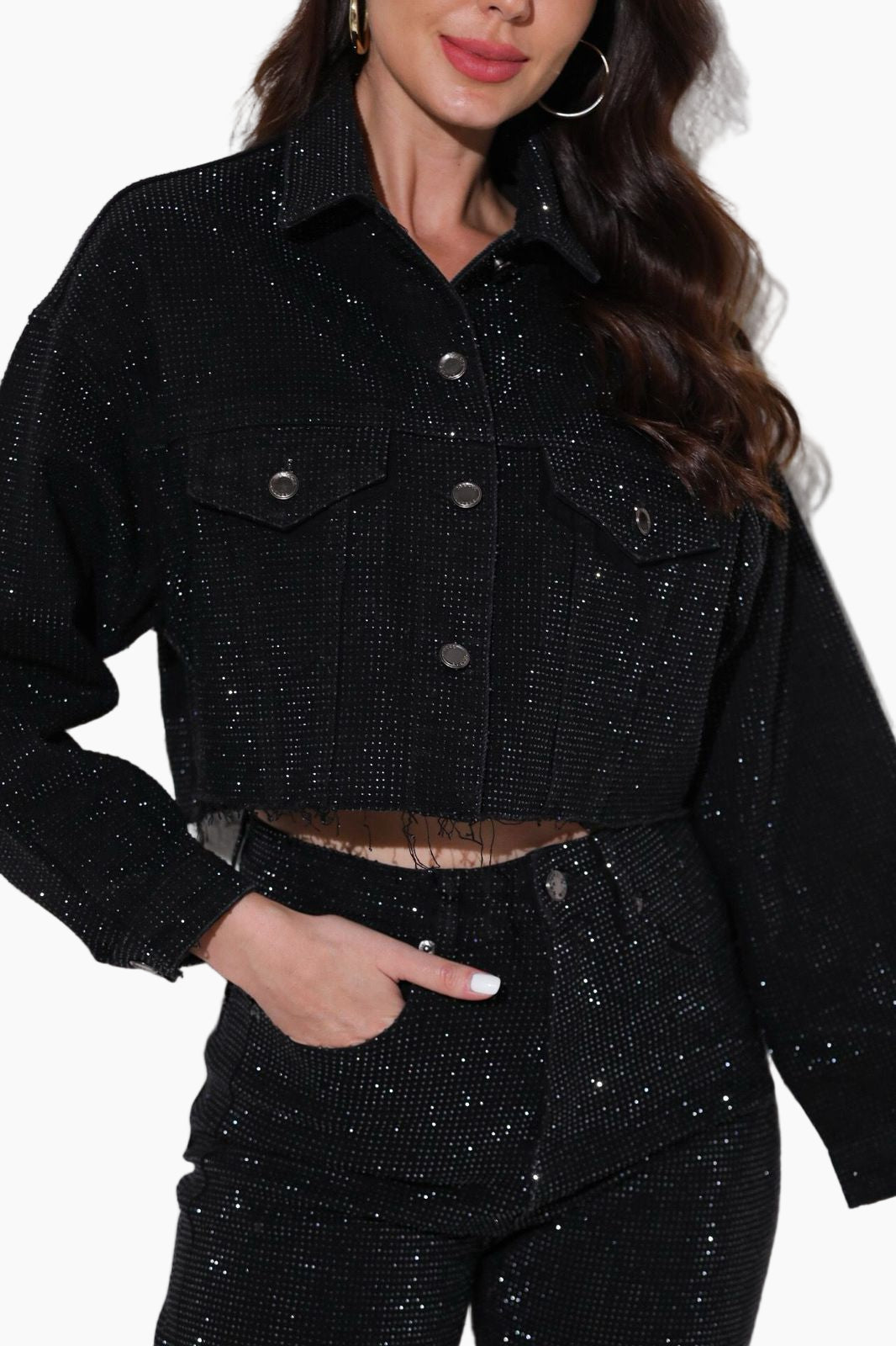 Black glittery jacket and pants worn by a person on a white background