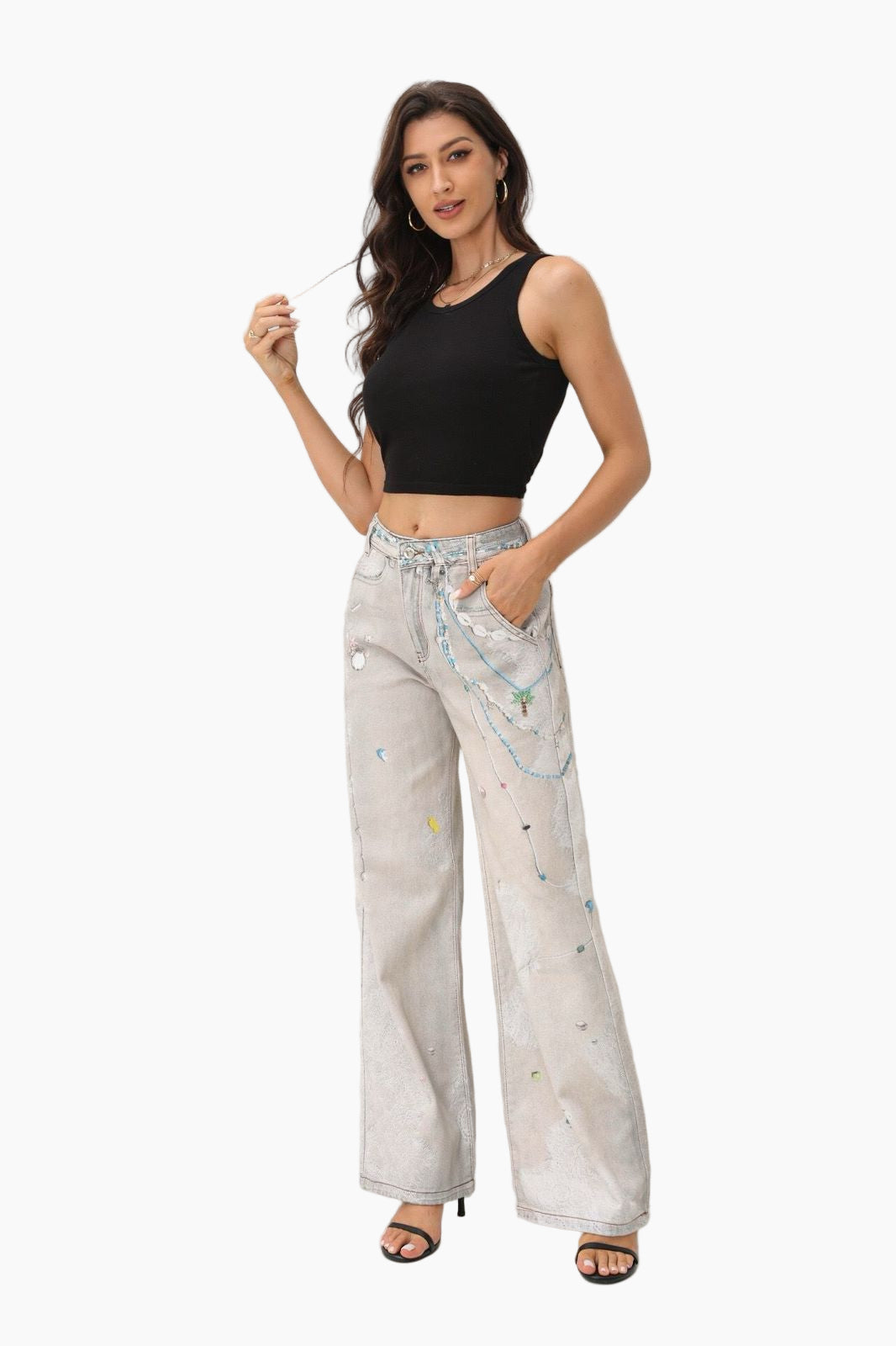 Woman wearing a black top and light-colored pants with patterns on a white background