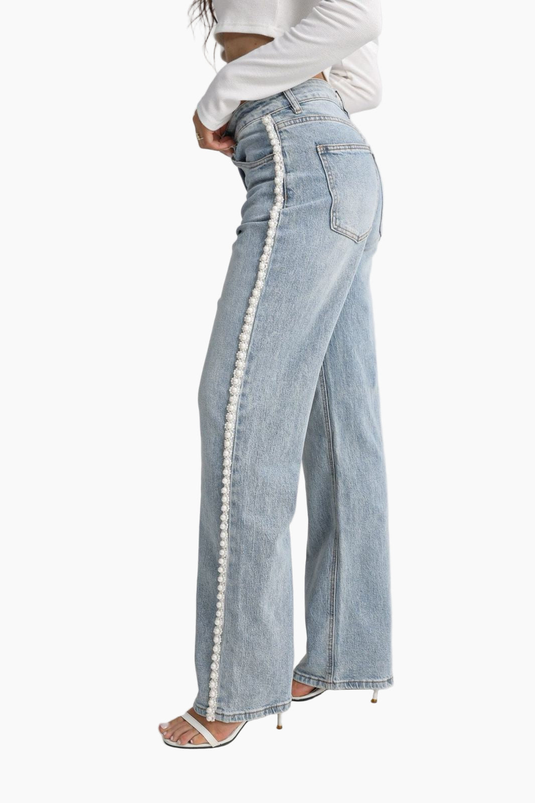 Light blue jeans with white trim worn by a person 