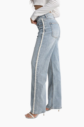 Light blue jeans with white trim worn by a person 