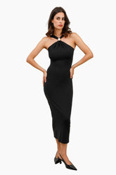 Woman wearing a black halter neck dress 