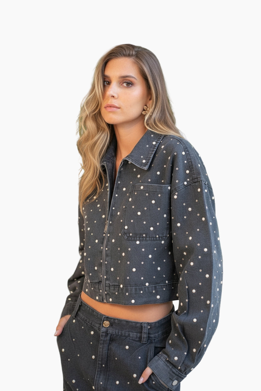 Woman wearing a dark denim jacket with white polka dots 
