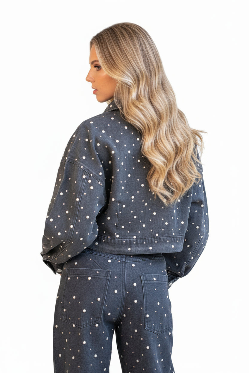 Woman wearing a dark denim jacket with white polka dots, featuring matching pants