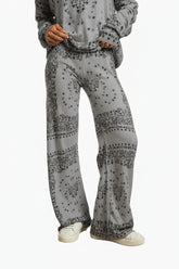 Person wearing a gray patterned outfit 