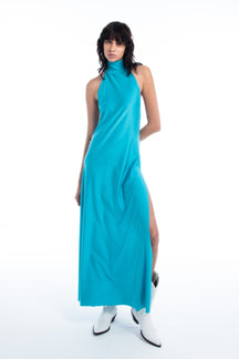 Woman wearing a turquoise dress with a slit 