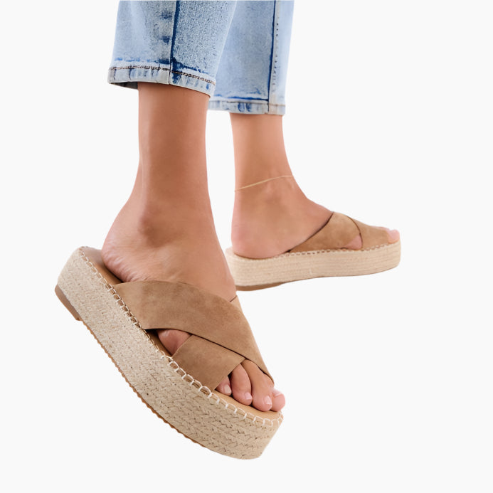 Brown espadrille sandals worn with rolled-up jeans 
