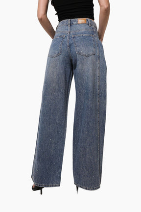 Person wearing blue jeans on a white background