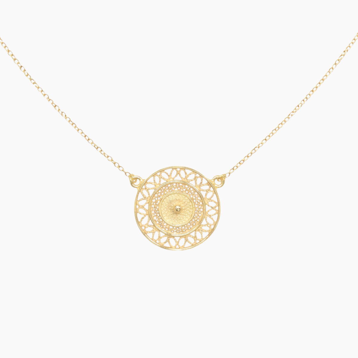Gold necklace with a intricate circular pendant 