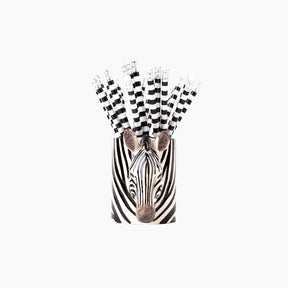 Zebra-themed paper straws with black and white checkered pattern in a holder