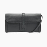 Black leather handbag with a visible brand logo 