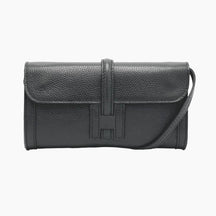 Black leather handbag with a visible brand logo 