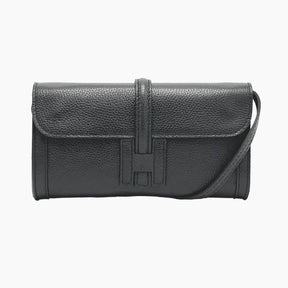 Black leather handbag with a visible brand logo 