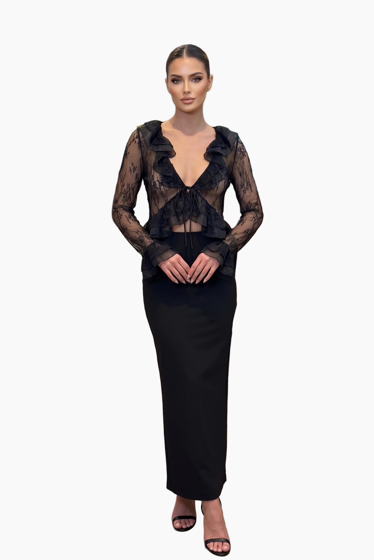 Woman wearing a black dress with sheer overlay on a white background