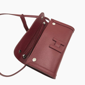 Maroon leather crossbody bag with visible brand logo on