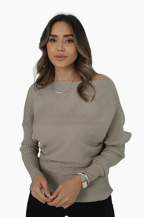 Woman wearing a beige ribbed sweater