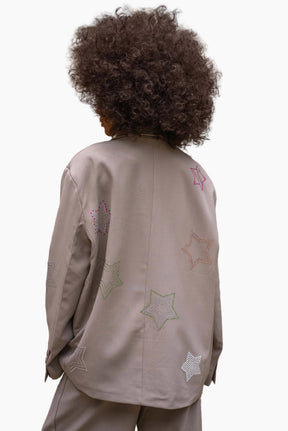 Person wearing a beige jacket with star patterns 