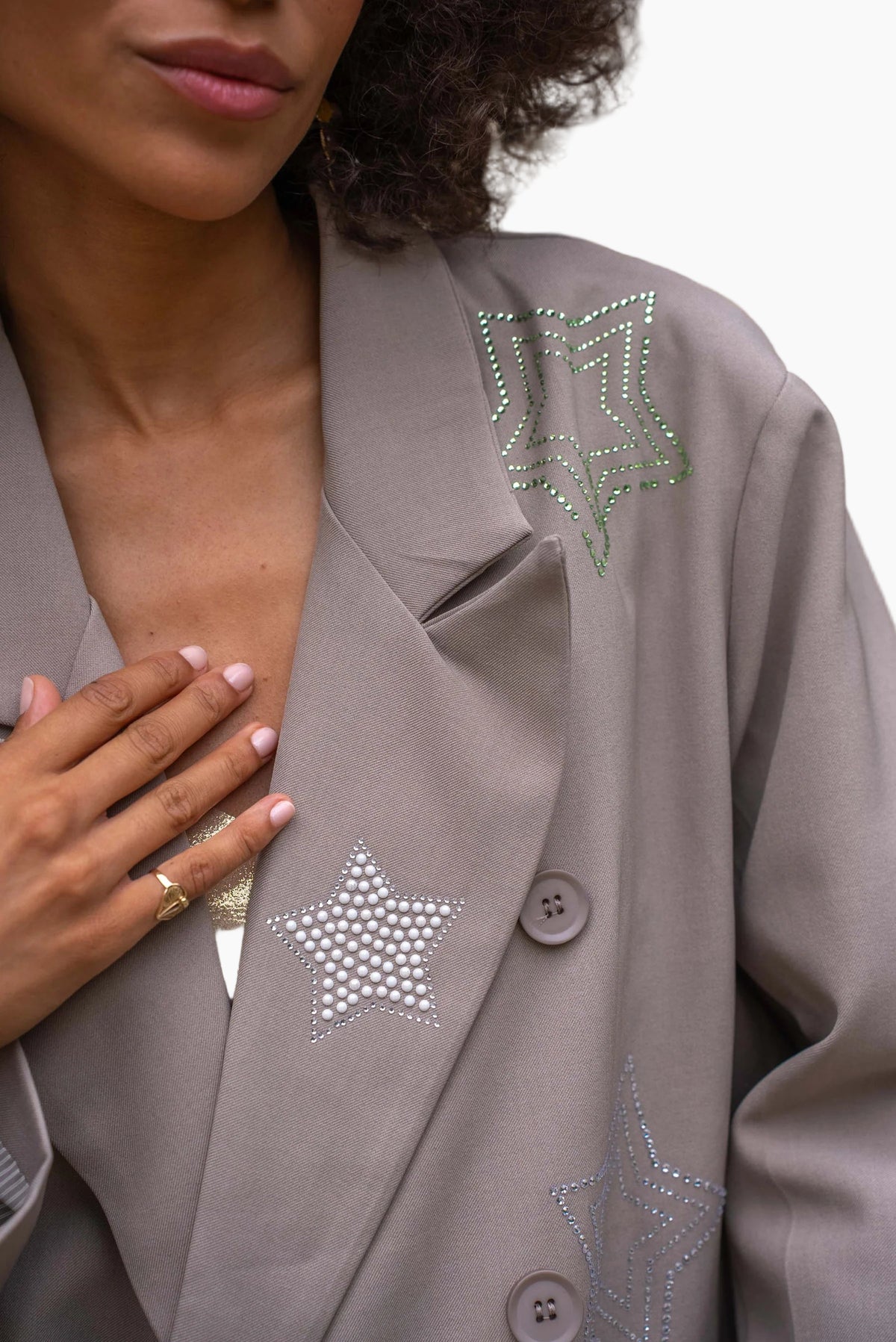 Close-up of a gray blazer with star-shaped embellishments 