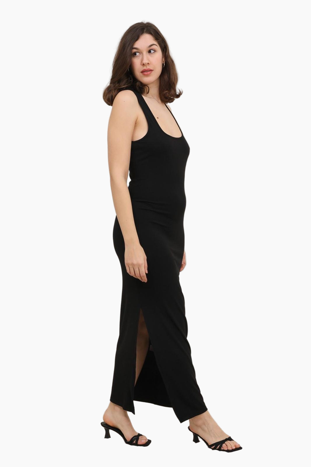 Woman wearing a black sleeveless dress with a slit 