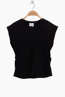 Black sleeveless top on a wooden hanger 