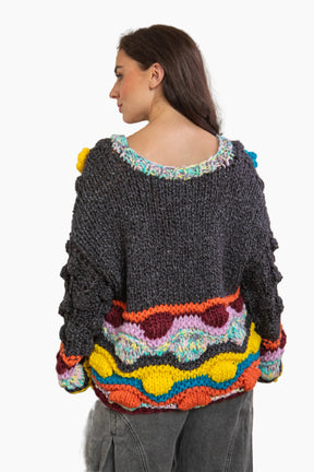 Woman wearing a colorful, patterned sweater 